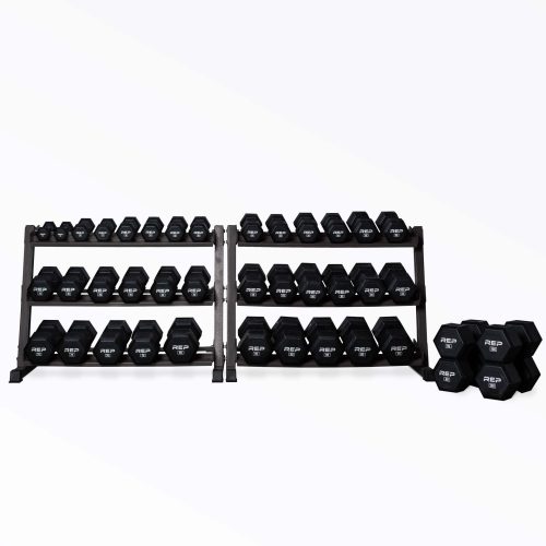 5-100lb Rubber Coated Hex Dumbbell Set stored on two REP Dumbbell Racks with the 95 and 100lb pairs being stored on the ground next to the racks.